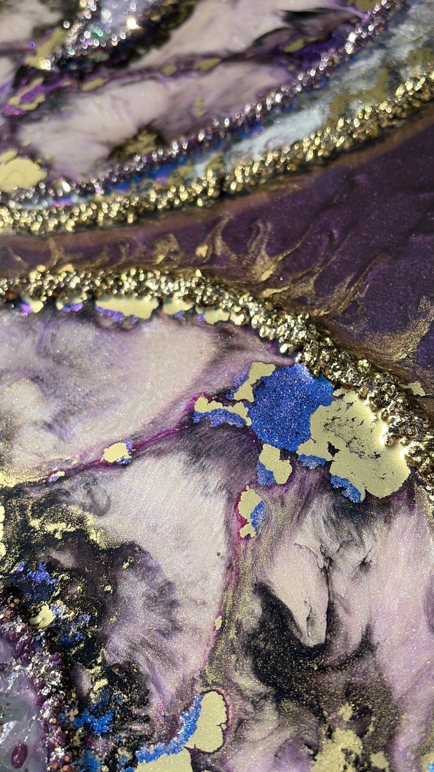 Close-up of maximalist artwork with textured surface with gold, purple, and blue colors.