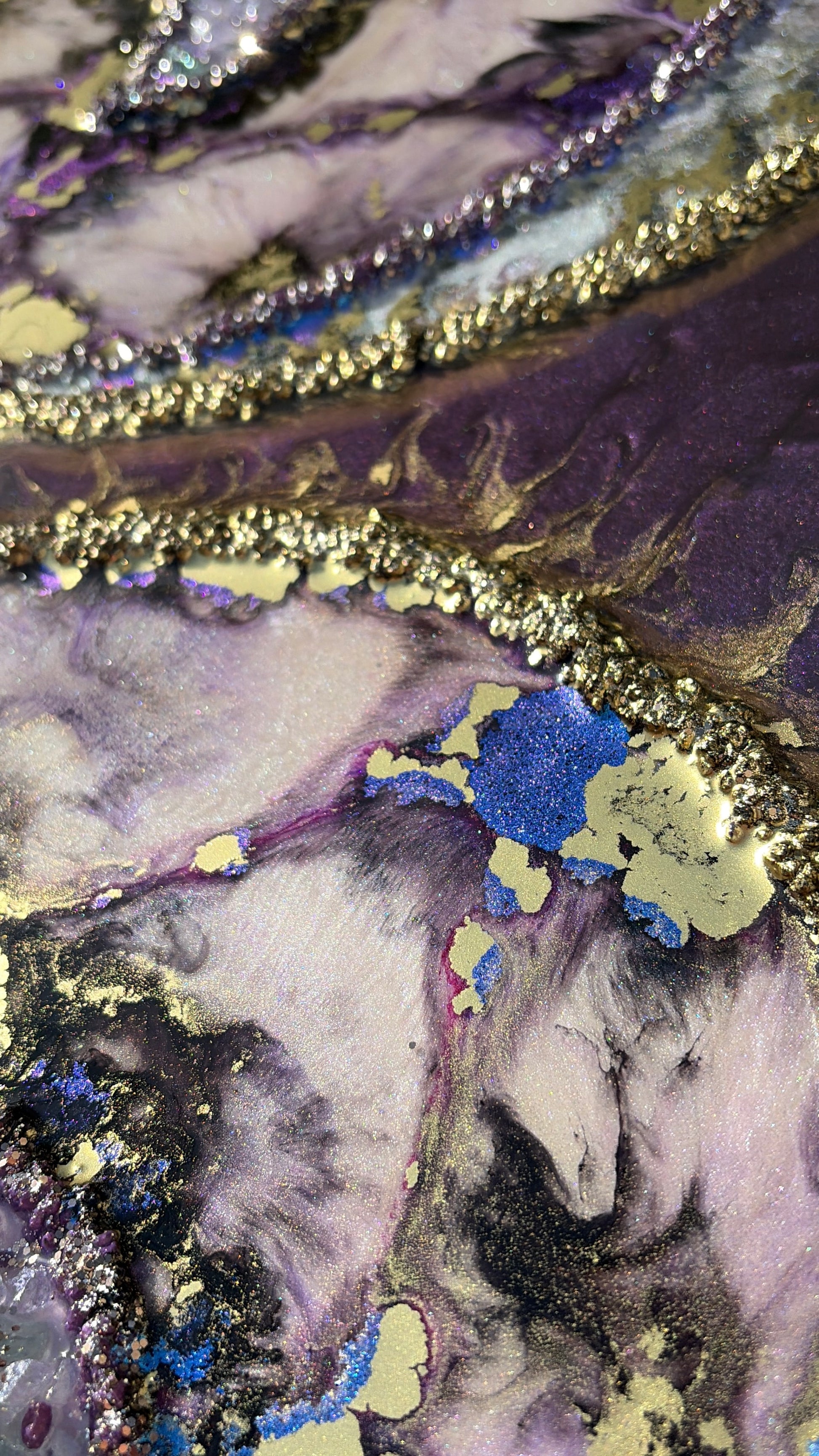 Close-up of maximalist artwork with textured surface with gold, purple, and blue colors.