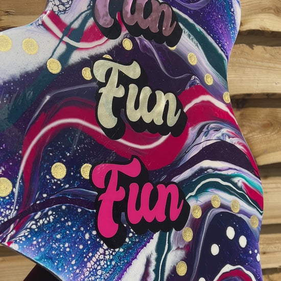 Fun bright and bold unique resin coated acrylic pour artwork in pinks, purples and blues with Fun Fun Fun type. Handmade in the uk by GCC Artworks